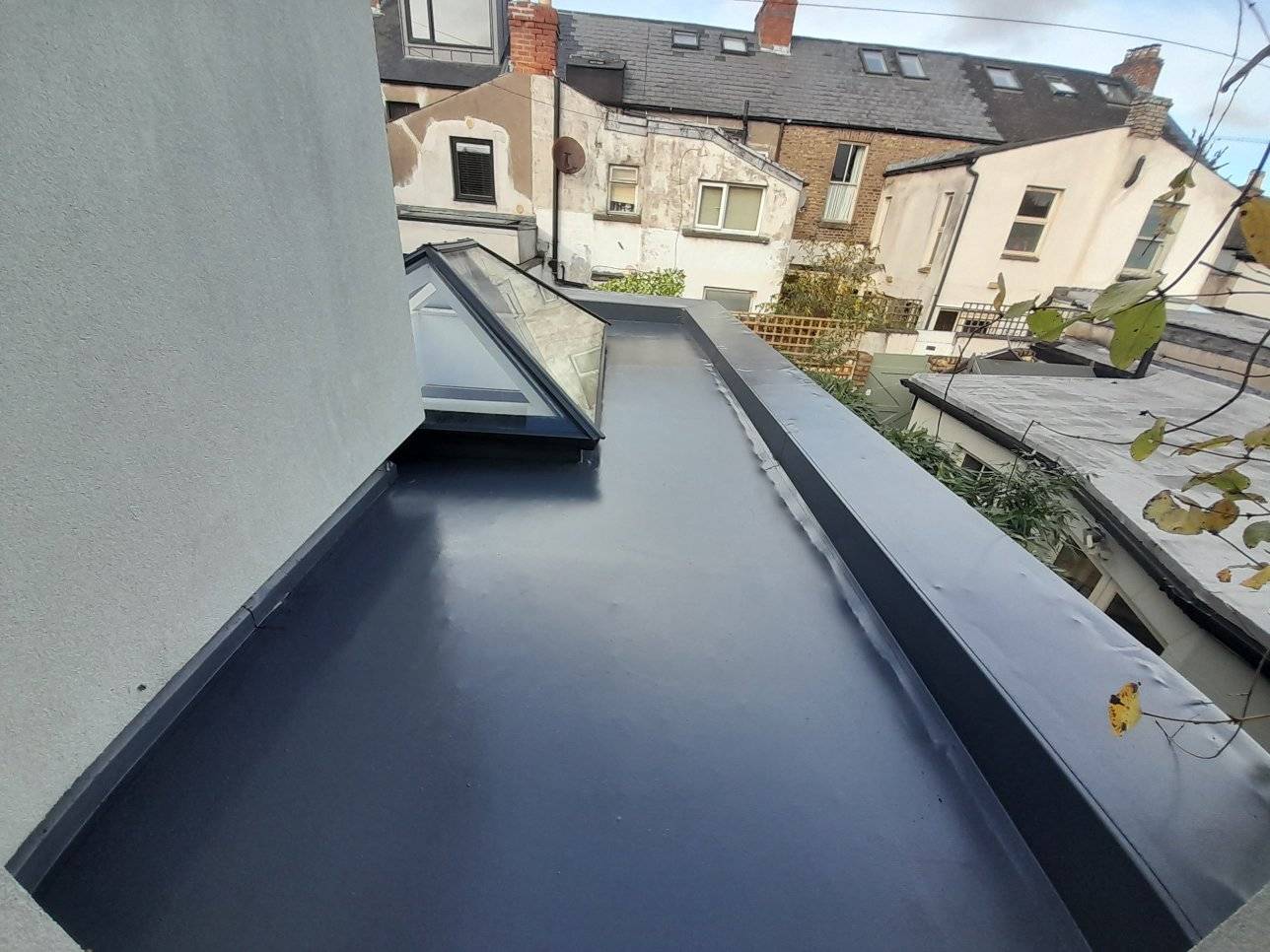 Flat roof with rubber coating applied to it after it had been replaced. 