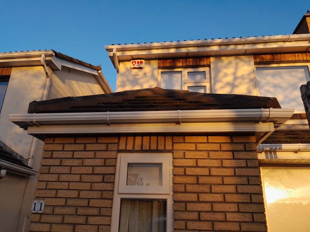 image of a house roof looking down on a lead valley and gutter in need of repair.