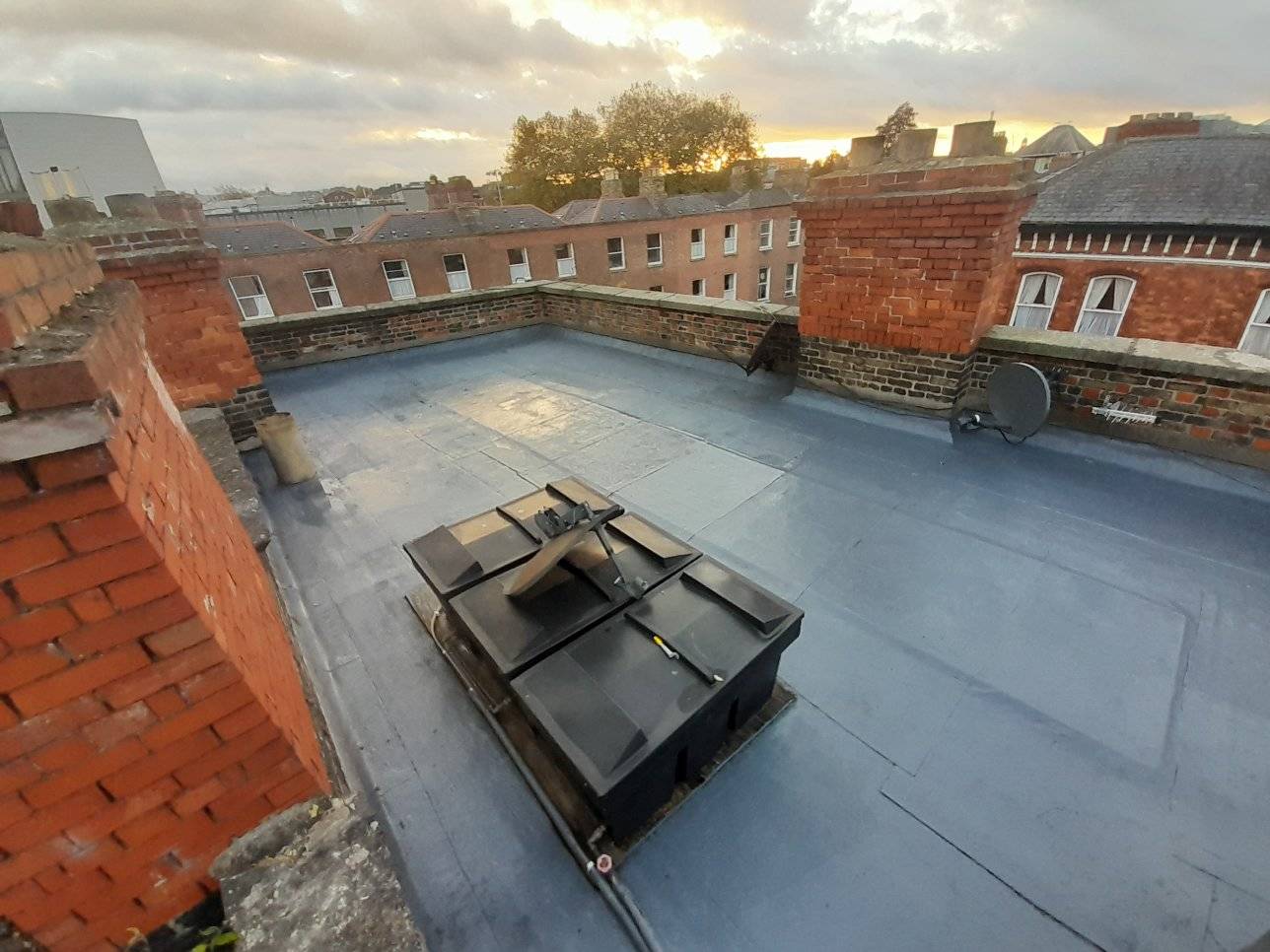 image of a freshly sealed roof and chimney in Dublin city with rubber coating applied.