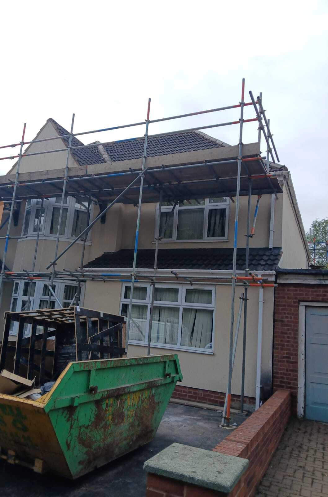 a flat roof in Dubin with leaking roof felt satellite dishes and water ank on top of it.