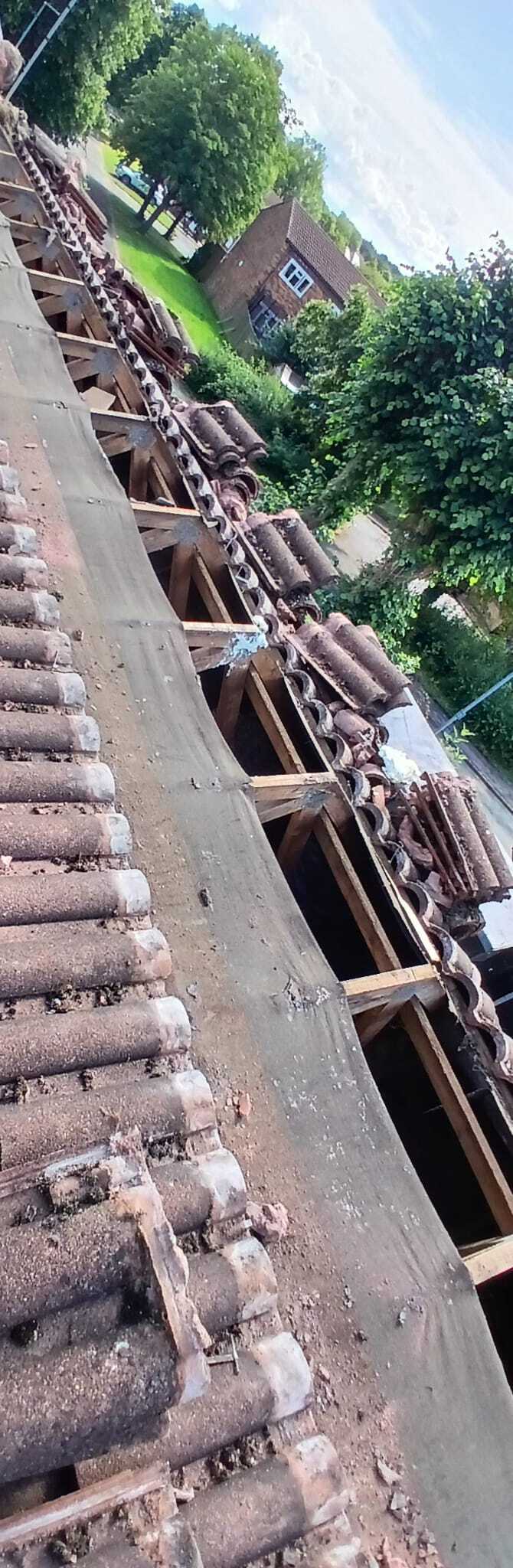 a red brick chimney on the flat roof with rubber seal around the bottom of the chimney