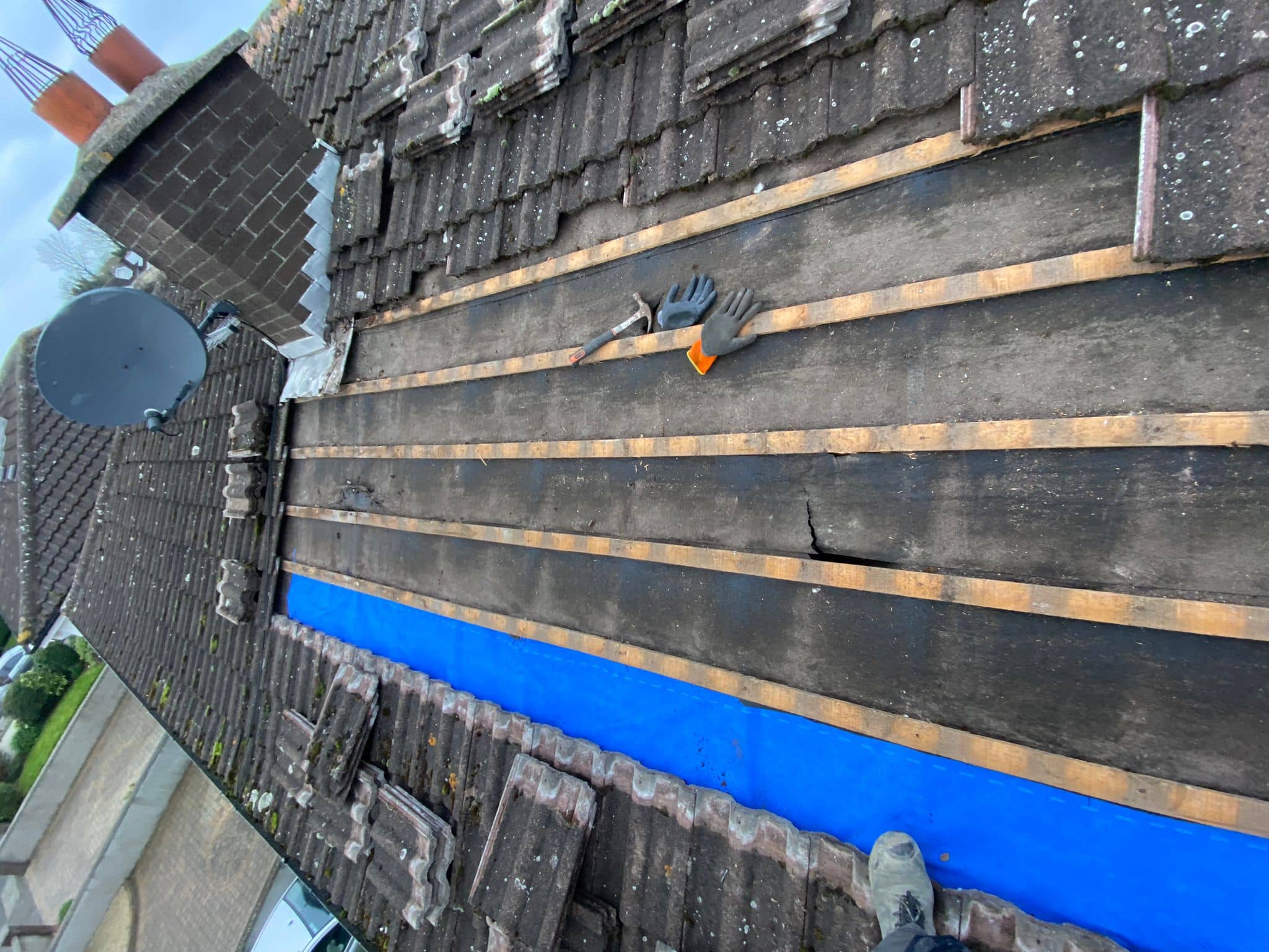 Roof tiles removed on a roof in Dublin and the membrane visible underneath.