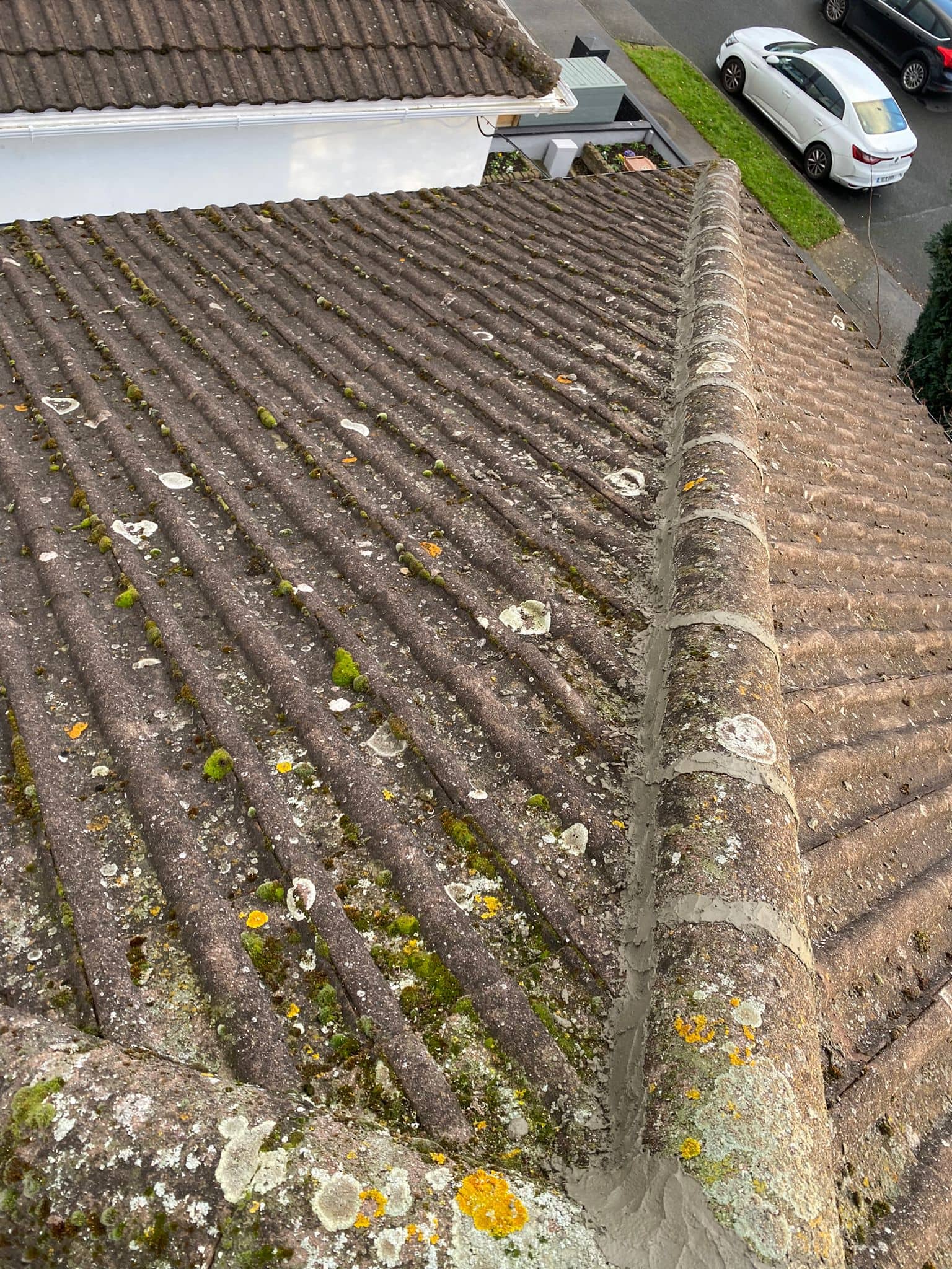 Roof capping tiles with fresh mortar applied to them.