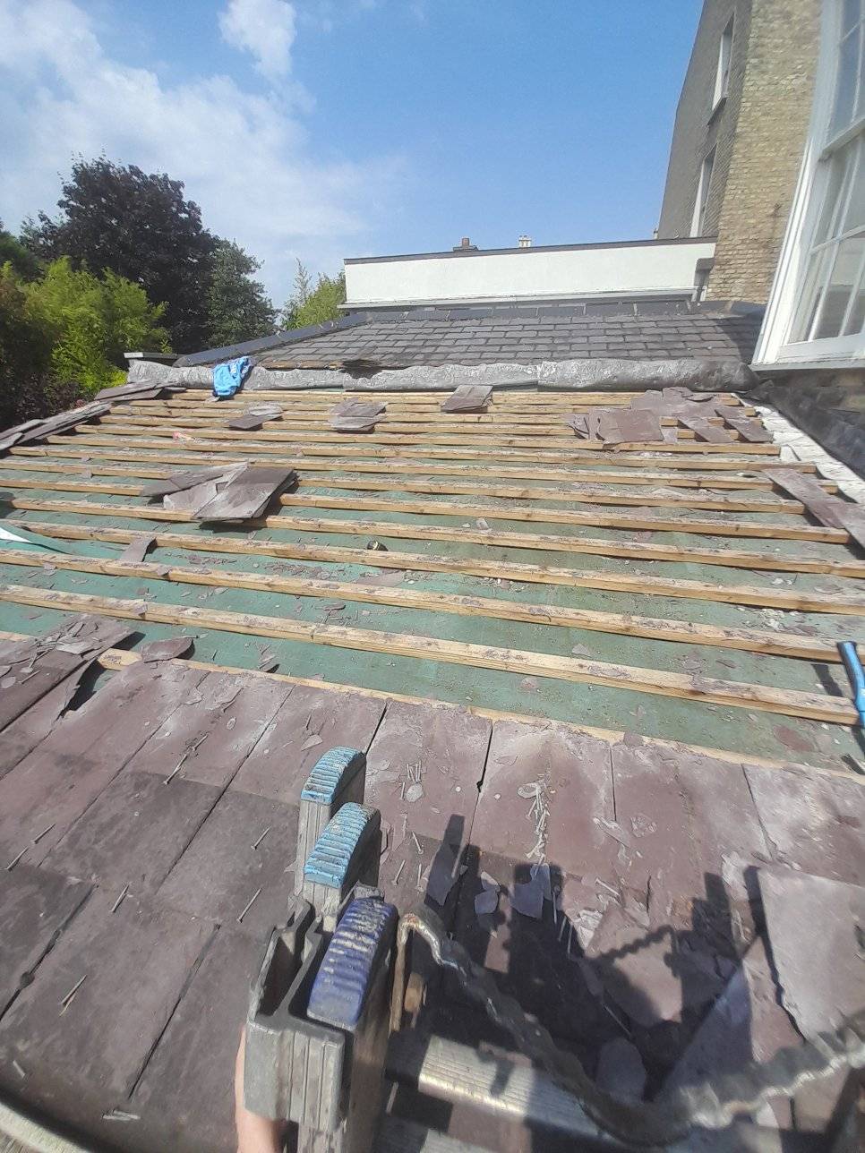 Roof being Repaired with tiles removed and underwood exposed in south Dublin.