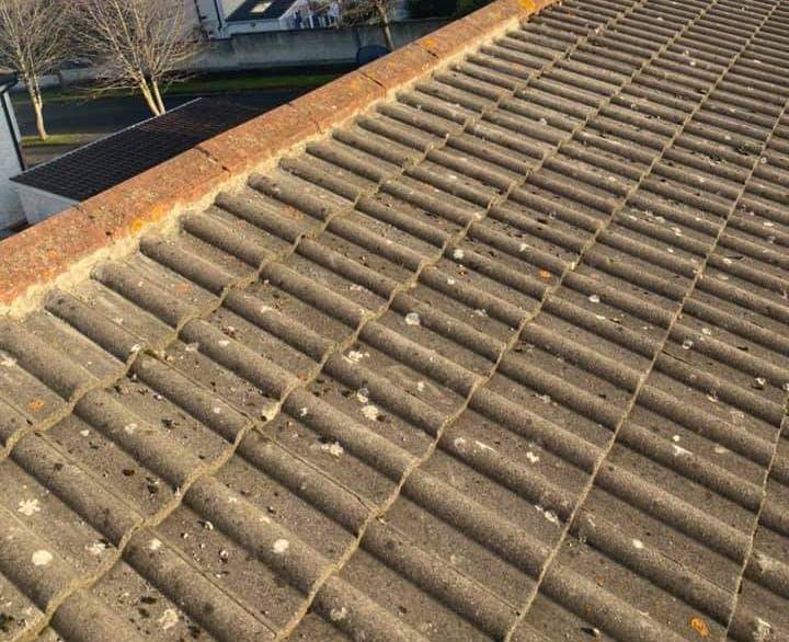 Image of tiles on a roof being re-pointed